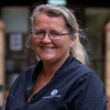 Headshot of care home manager, Annmarie Porter. She has blonde hair, glasses, and is wearing a navy uniform