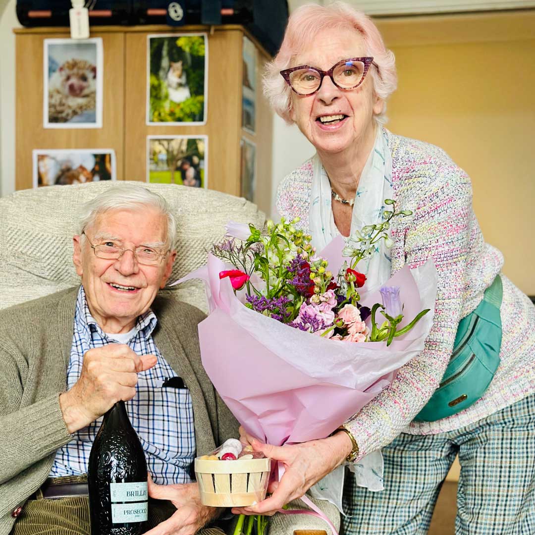 Glencairn rsidents Gavin And Olive exchange gifts - chocolate, prosecco, and flowers for Valentines day. 