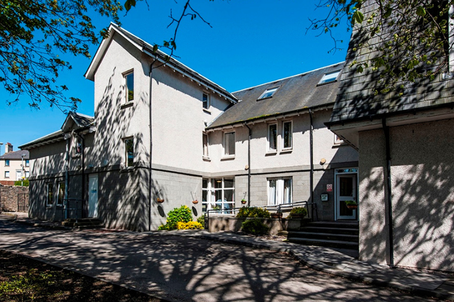 Torry Care Home Exterior: A white and grey building 