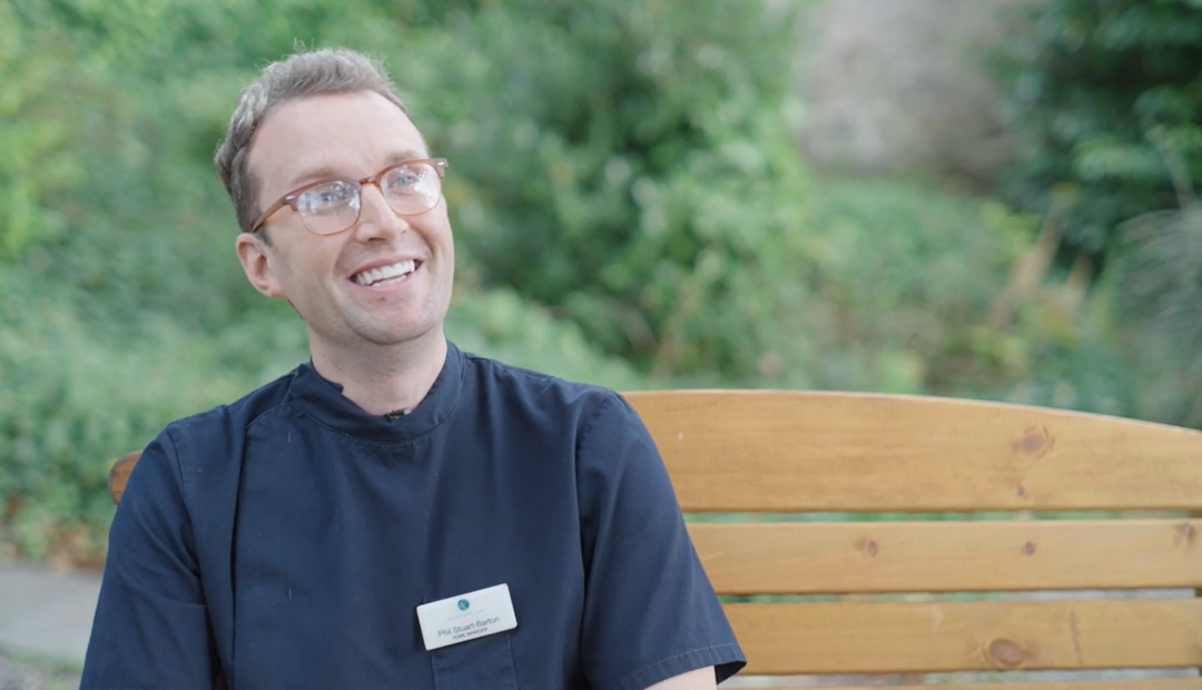 Phil Stuart Barton, Home Manager sits in the care home garden