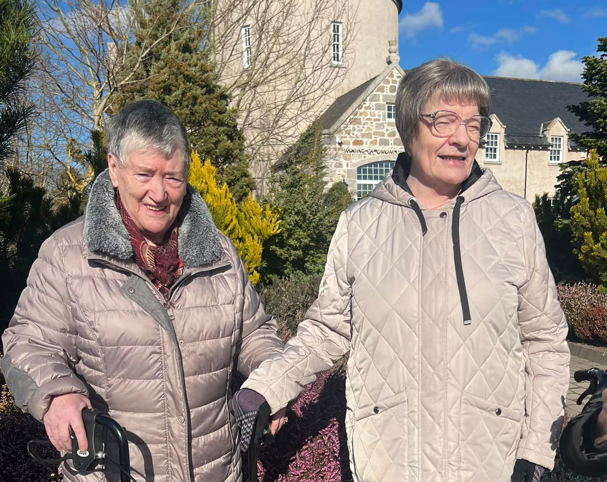 Care home residents enjoy a walk outside