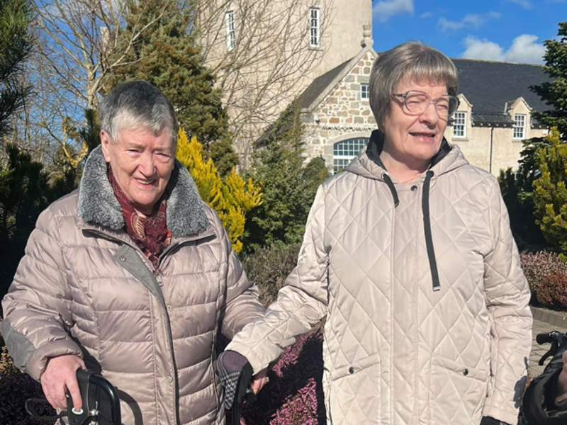 Care home residents enjoy a walk outside