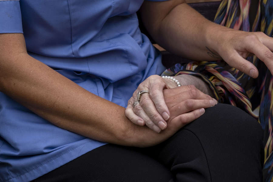 Detail: Two hands holding, caring