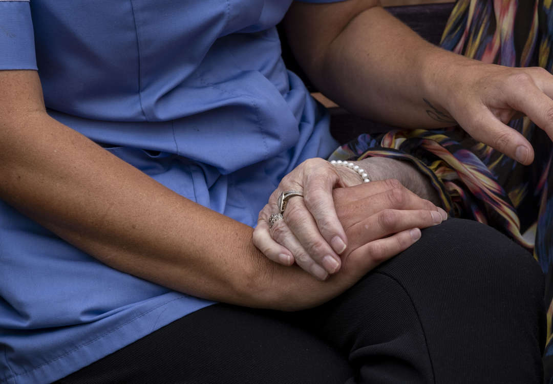 Detail: Two hands holding, caring