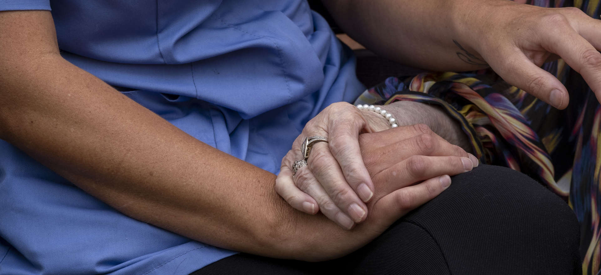 Detail: Two hands holding, caring